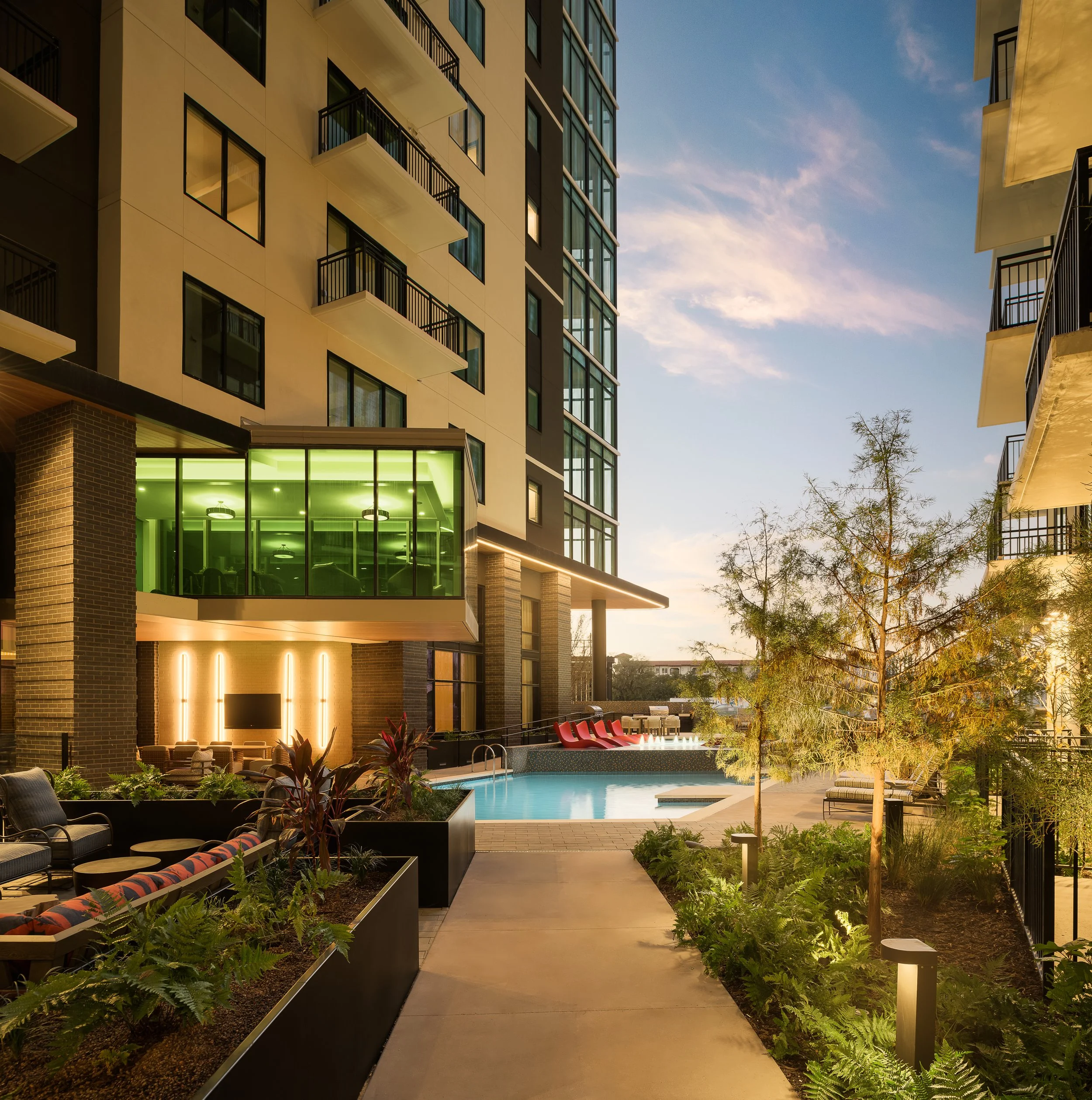 Mixed-use commercial Lush commercial outdoor pathway with tropical landscaping and stone flooring — commercial architecture photographyCommercial outdoor walkway with landscaping and modern architectural details — commercial architecture photographyd