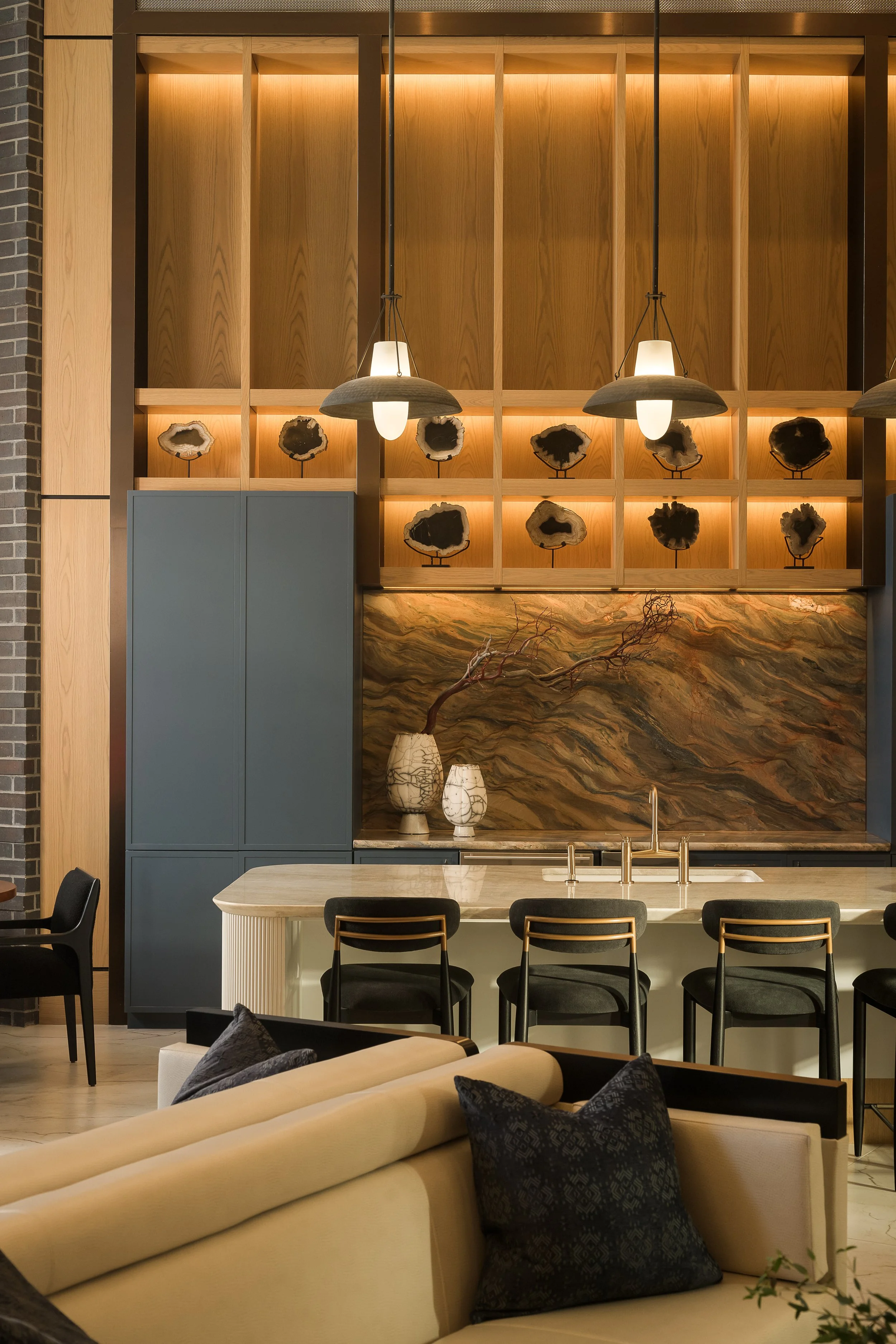 Backlit bar shelving with marble countertop and artisan pendant lighting — luxury apartment interior photography, The Oliver Dallas TX