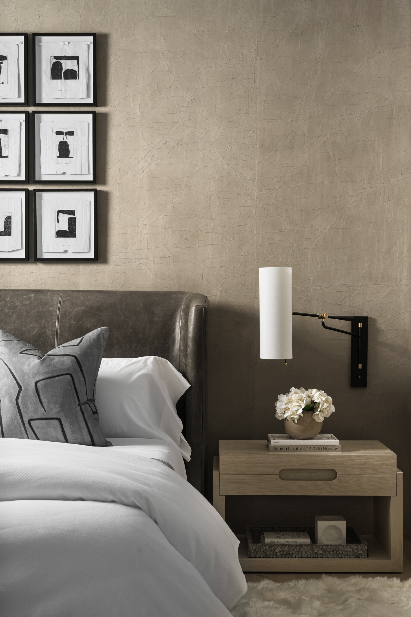 Contemporary hotel guest room with neutral bedding and soft lighting — hospitality interior photography