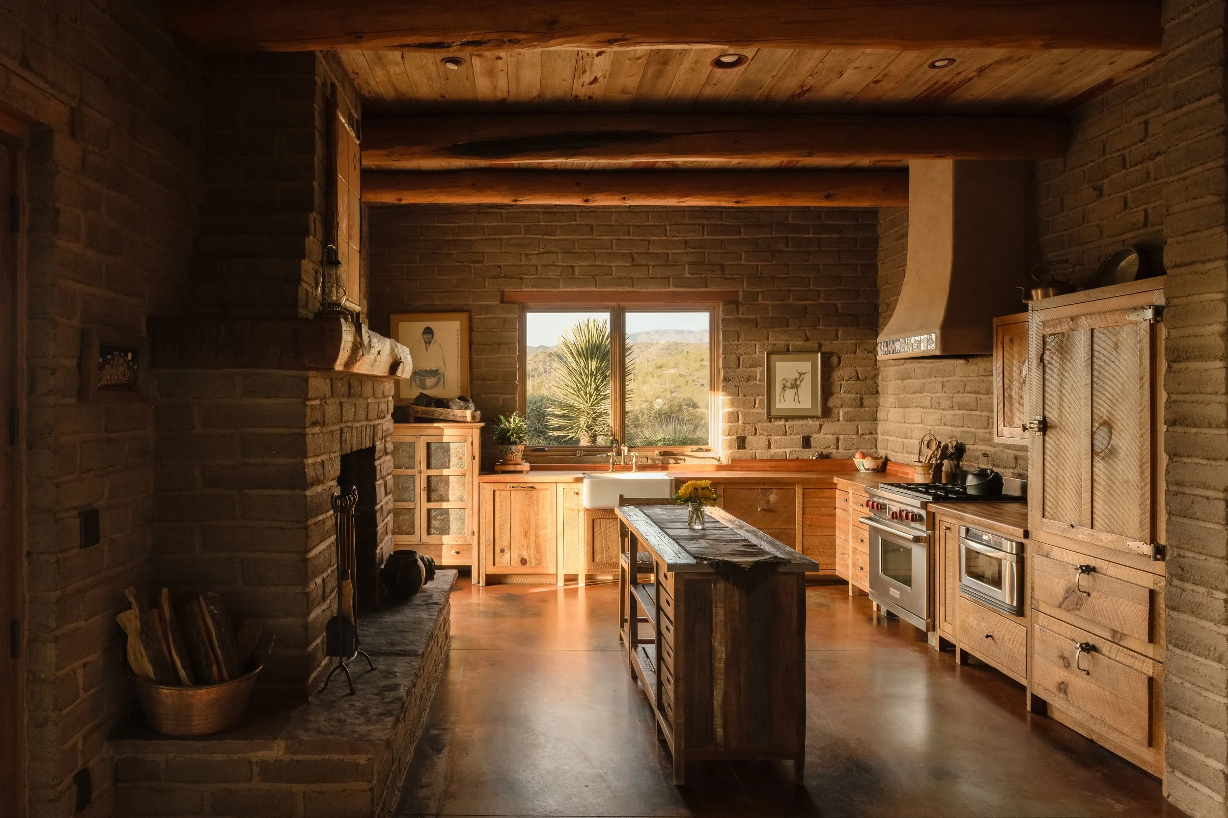 Rustic luxury kitchen with wood beam ceilings, exposed stone, and custom cabinetry — residential interior photography Arizona