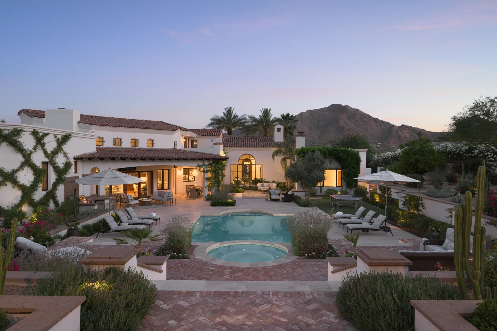 Desert resort pool and courtyard at sunset with mountain backdrop — commercial architecture photography Arizona