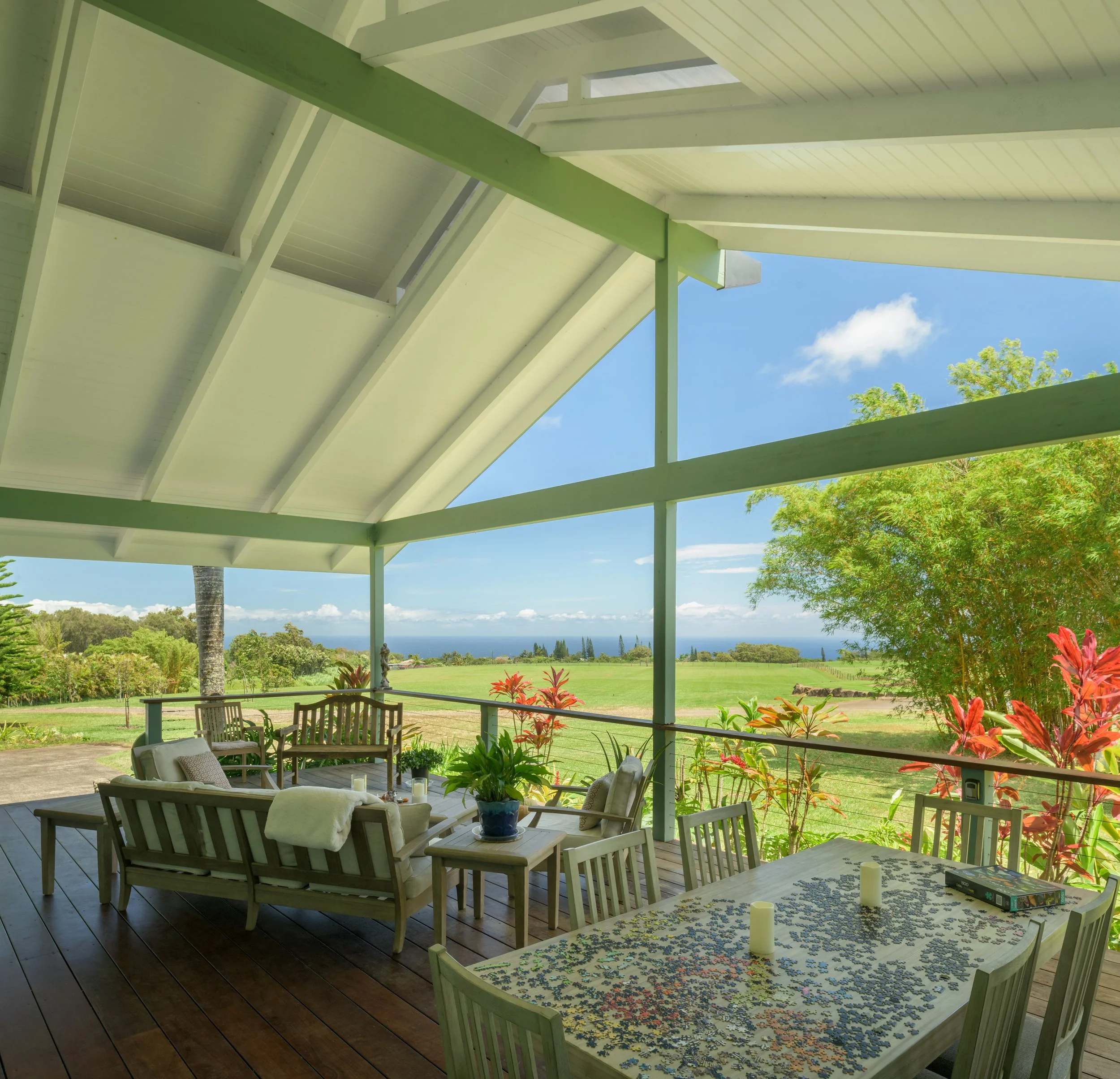 Covered outdoor lanai with tropical views and outdoor dining — residential architecture photography Hawaii