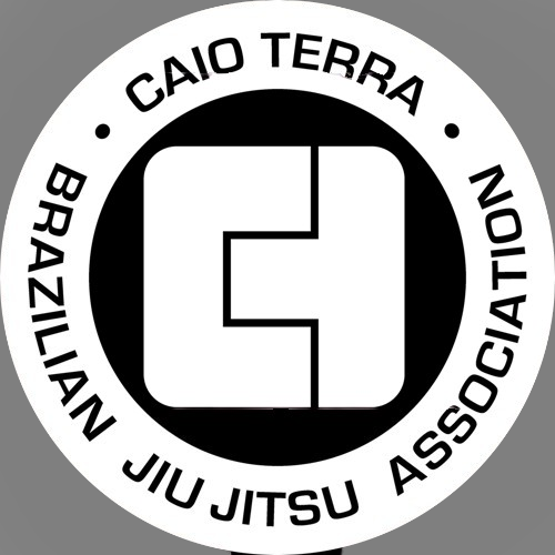 Logo circular en blanco y negro con el texto 'Caio Terra Brazilian Jiu Jitsu Association' alrededor y un emblema en el centro que combina las letras 'C' y 'T'.