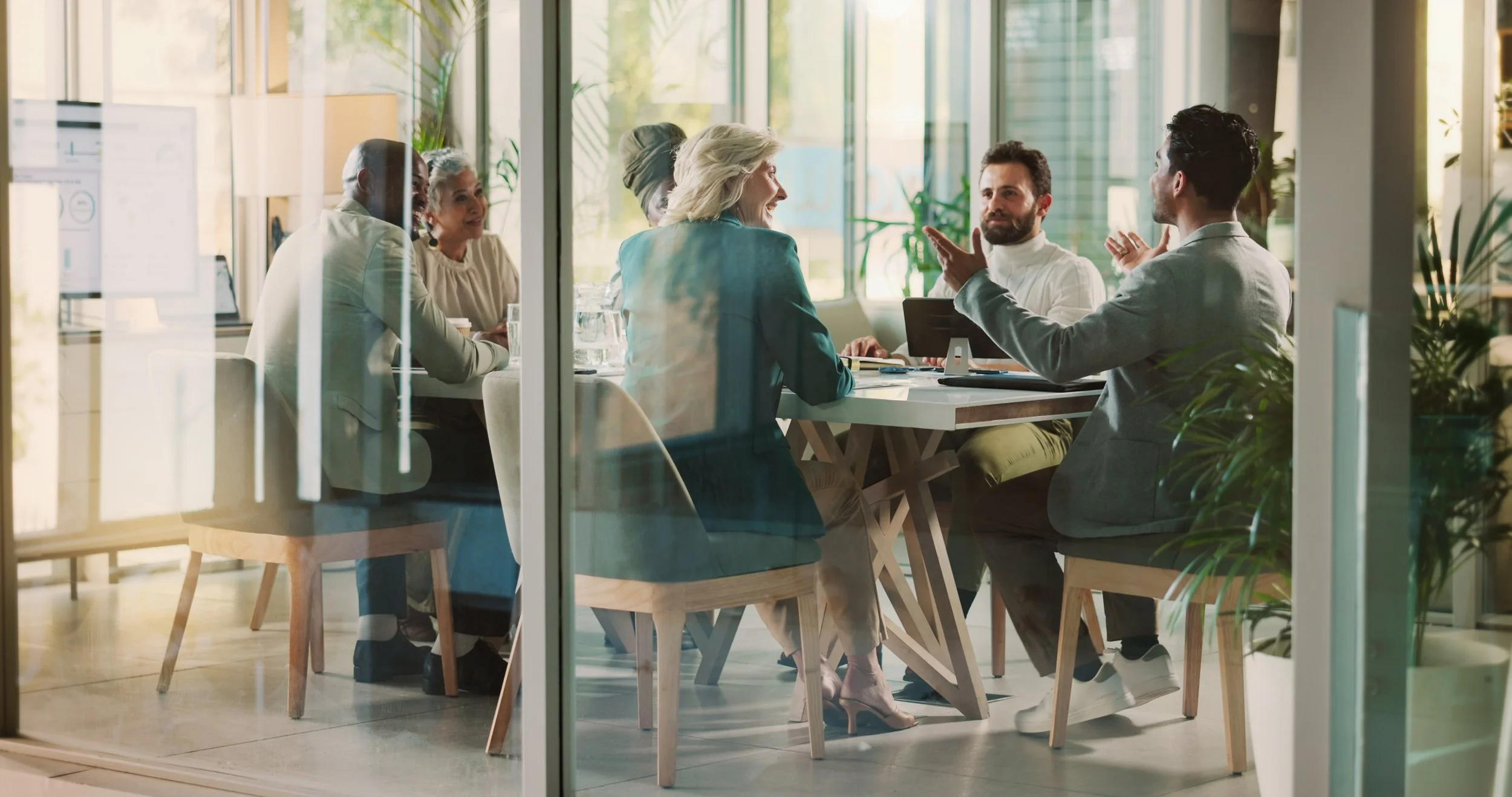 A team of people are discussing a project in a boardroom. Problem solving together in a professional setting.