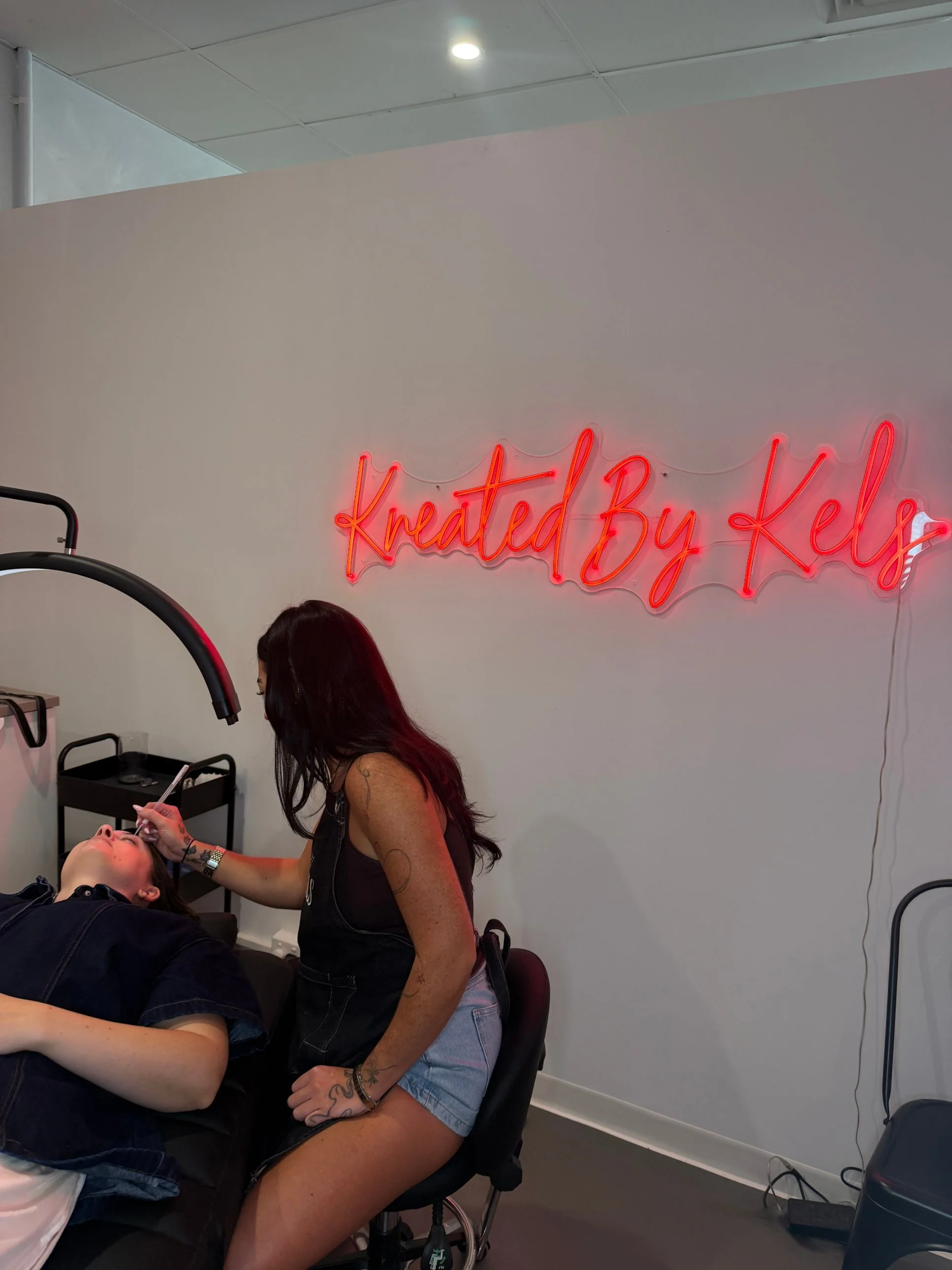 Woman waxing eyebrows in beauty studio