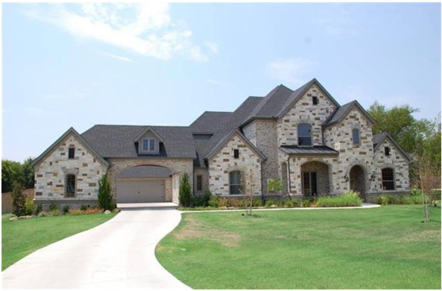 Outside shot of a custom-built luxury European inspired country estate in Keller. The highlights are the covered drive through garage breezeway, arched entryways and estate home feel. 