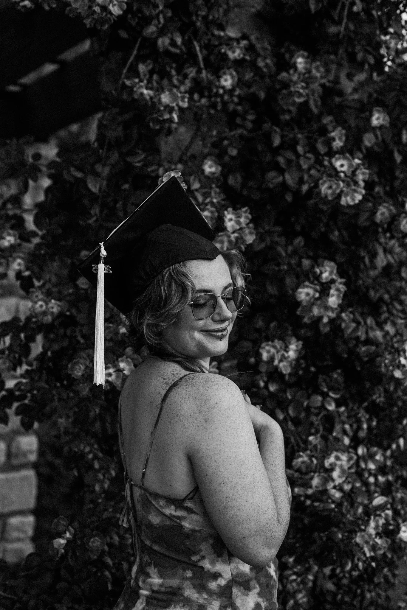 A black and white photo of journalist Hali Smith in their graduation cap.