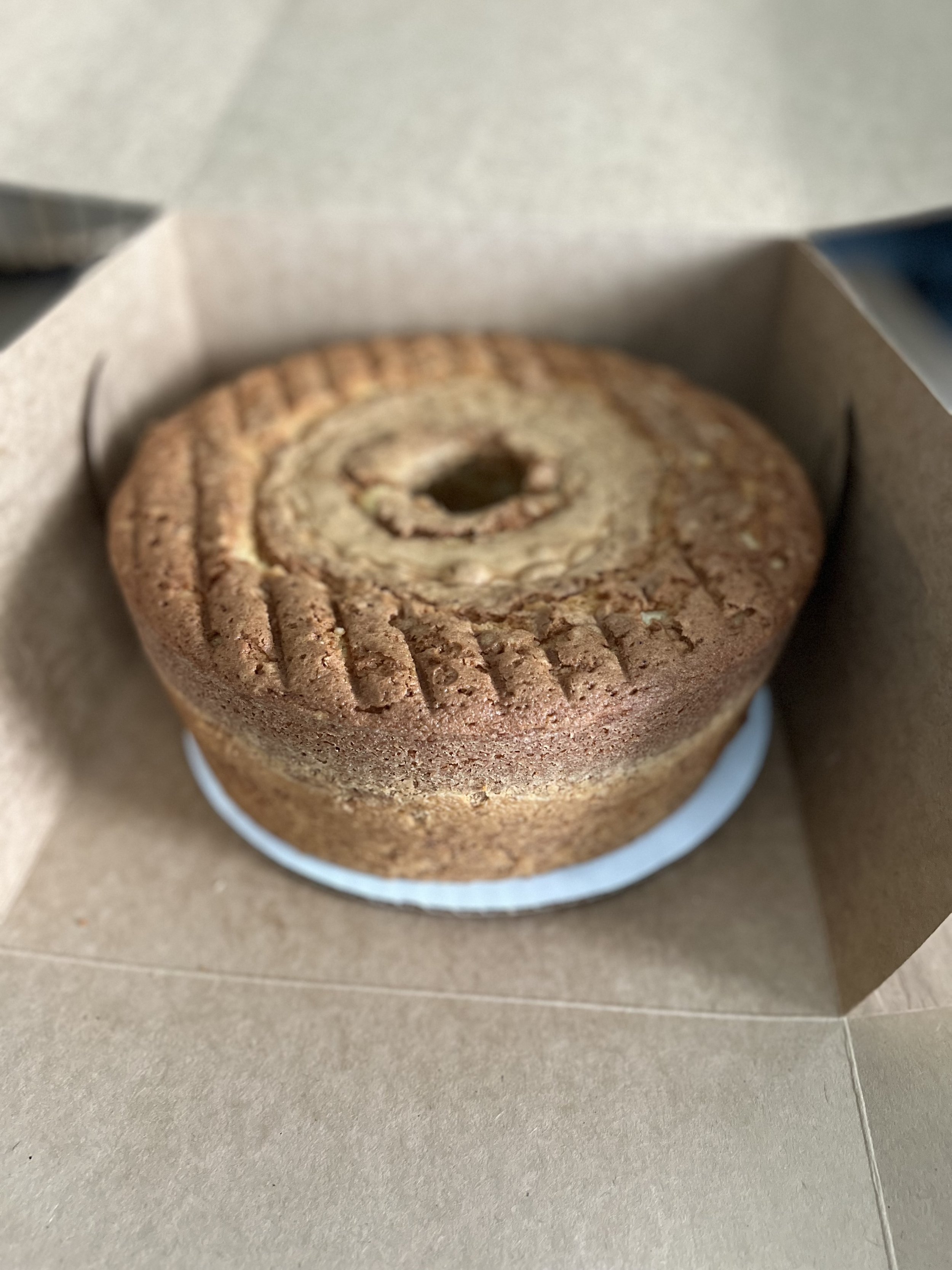 A wrapped current chocolate chip cookie inside a box.
