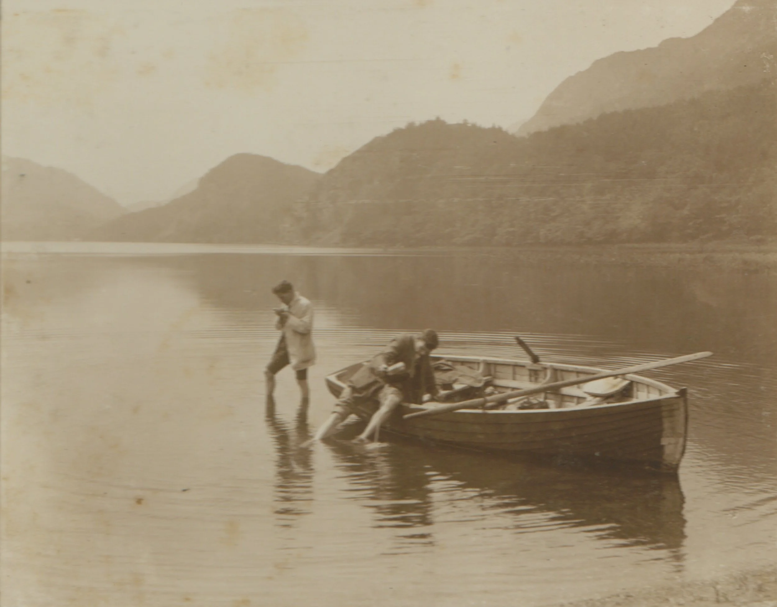 Two men "messing about in an old tub", from a 1914 photo album. 