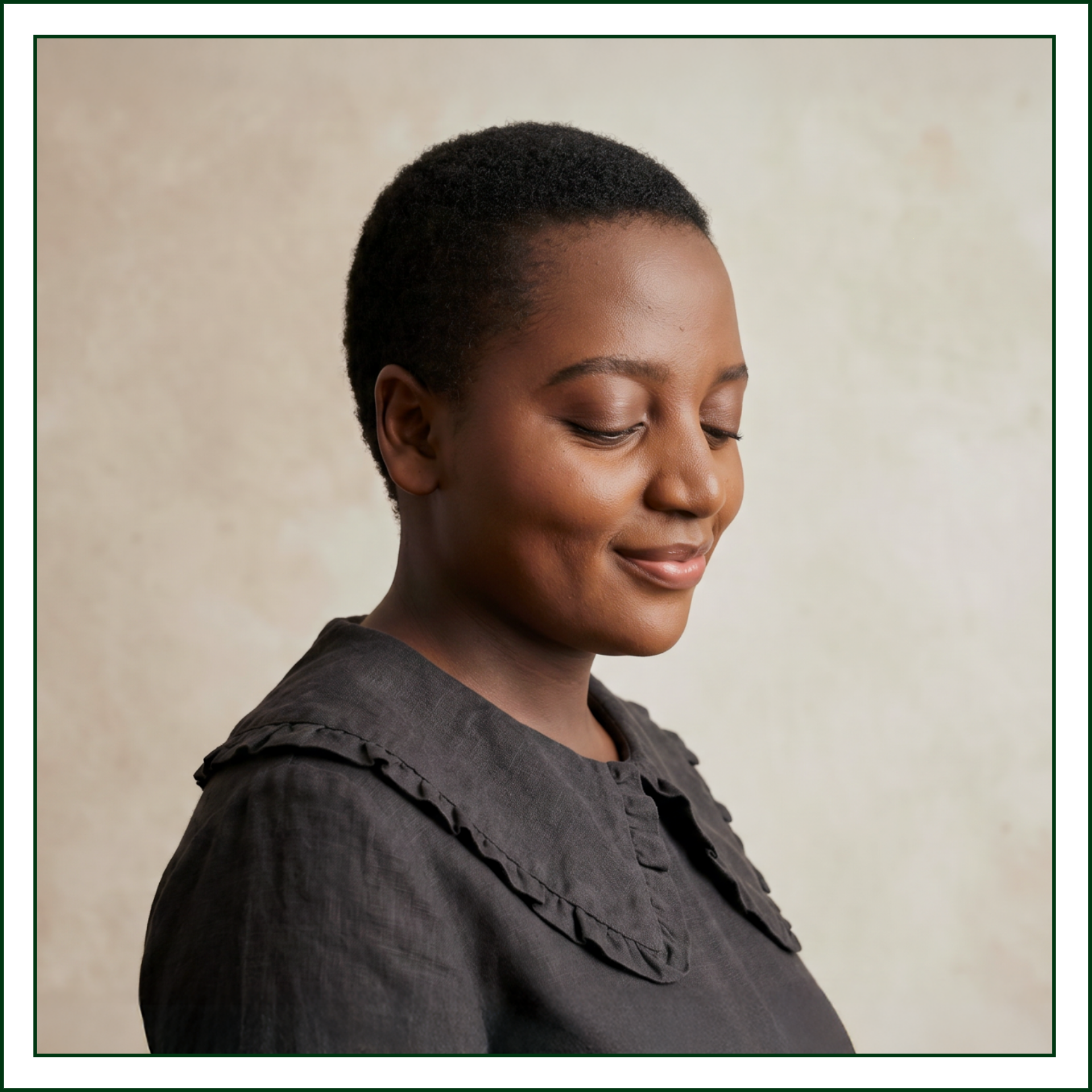 studio-kalili-website-design-studio-profile-downward-gaze-square.png	Brand designer and founder of Studio Kalili, in a charcoal ruffle-collar linen top with a downward gaze against a warm neutral wall.