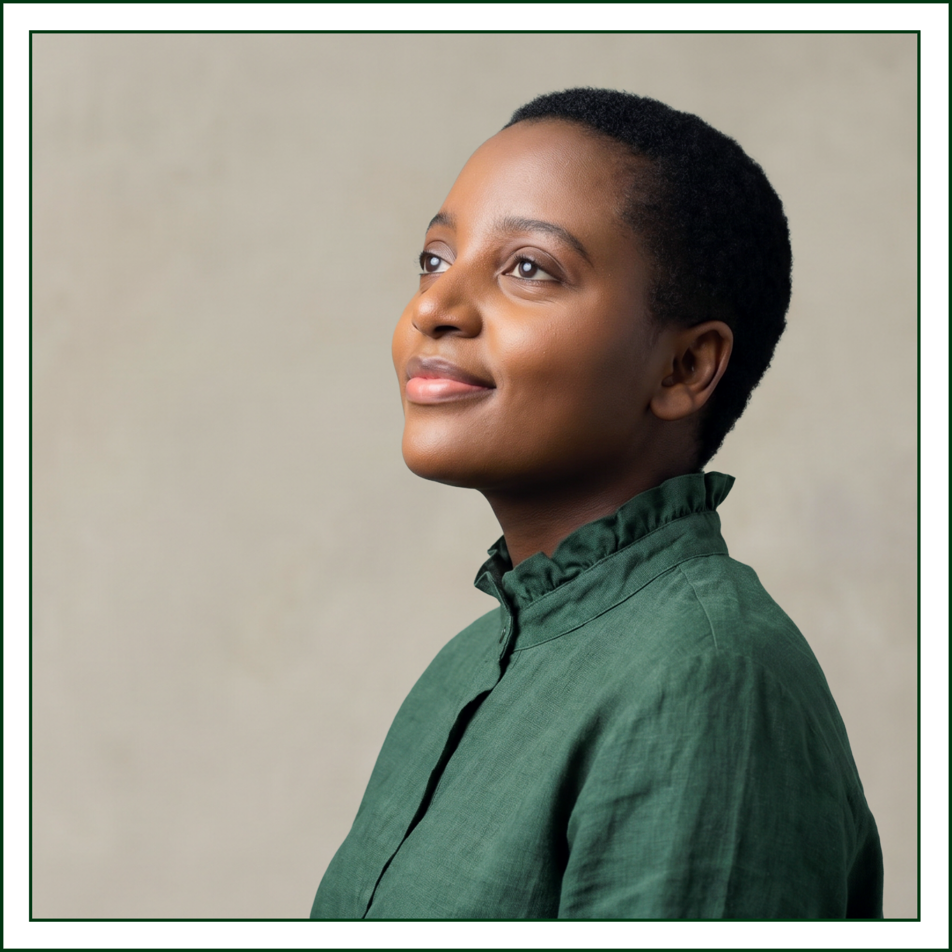 Profile portrait of Lillian Ingabire of Studio Kalili, a brand identity studio in Chicago, in a green linen shirt, looking upward confidently, against a warm neutral backdrop.