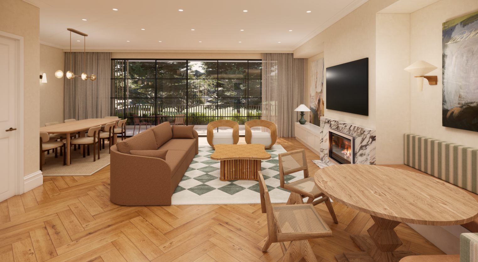Living room with a brown sofa, wicker chairs, a fireplace, a large window showing greenery outside, and a dining area with a long table and chairs.