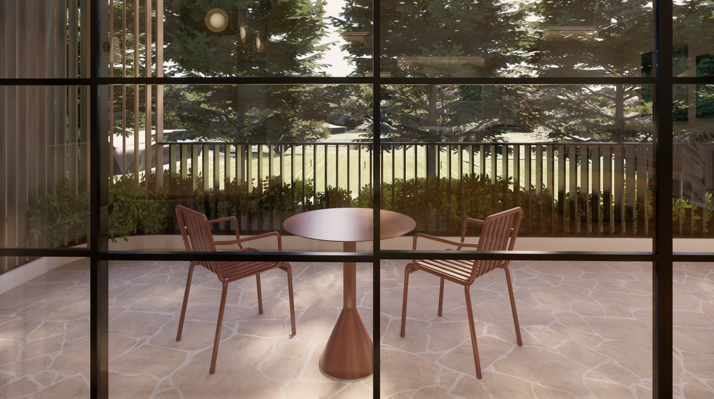 Room with a round wooden table and two wooden chairs on a beige stone floor, viewed through large glass windows with a view of green trees and a lawn outside.