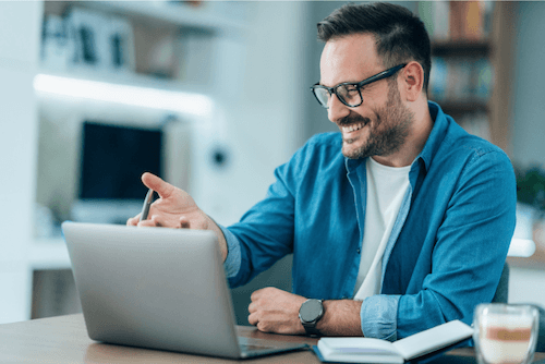Happy man having a conversation via telehealth with Unscripted Medicine for wellness & longevity