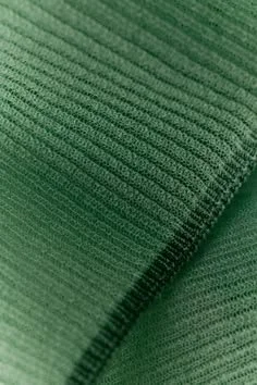 Close-up of green fabric with ribbed texture.