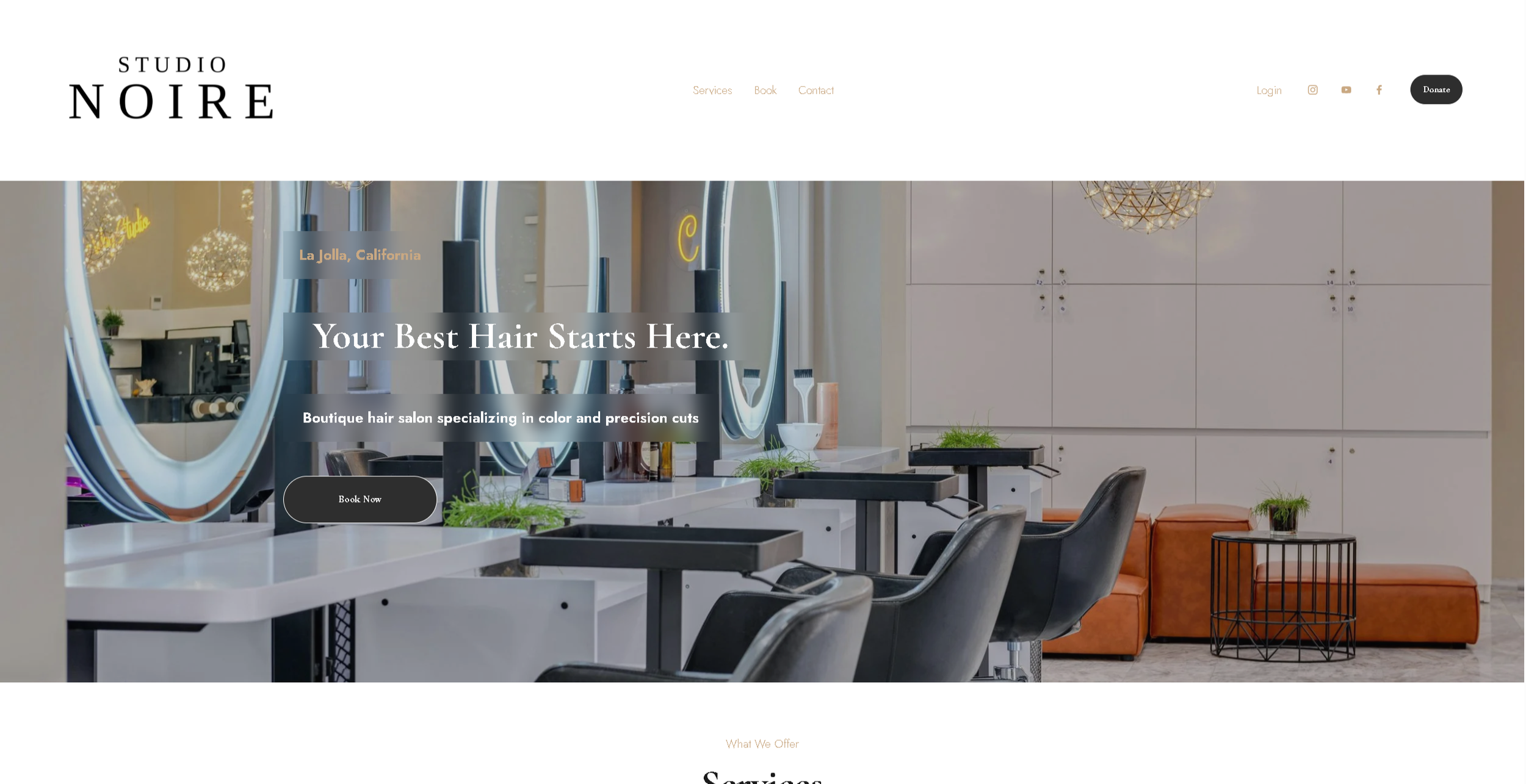 Homepage of Studio Noire featuring a modern hair salon interior with styling stations, mirrors, salon chairs, ambient lighting, logo, navigation, and a call-to-action button for bookings.