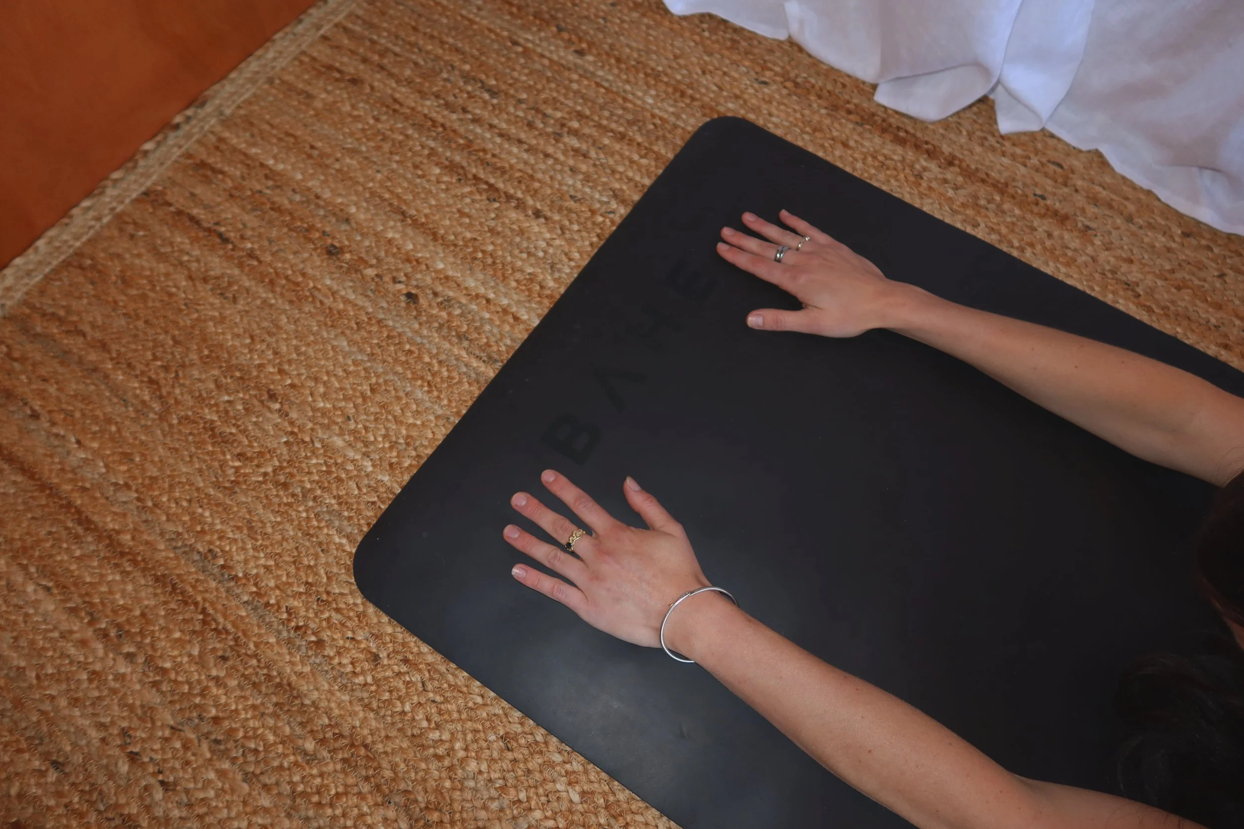Hands positioned on a Pilates mat during a mat Pilates session at Pillie Pilates.