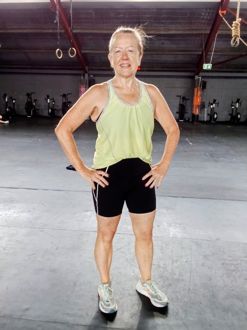 Woman over 40 standing confidently in a gym representing improved energy and vitality through personalised nutrition
