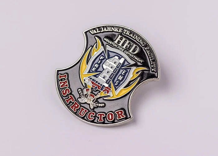 A badge with the text 'Val Jahnke Training Technologies Federal Houston Fire Department Fire Rescue' and 'Inspector 1969', featuring a firefighter's mask, a fire truck, and a fire helmet with flames.