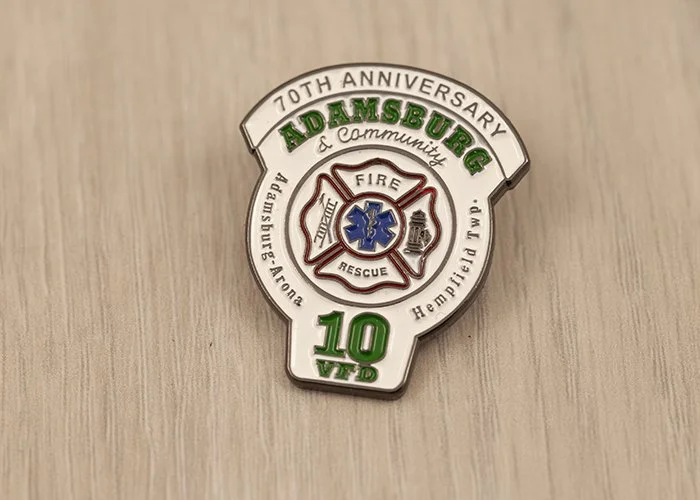 Pin commemorating the 70th anniversary of Adamsburg Fire & Community in Adamsburg, Pennsylvania, with a firefighter's badge in the center and green and white lettering.