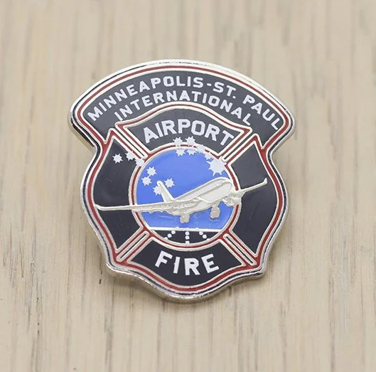Minneapolis-St. Paul International Airport Fire Department pin with airplane emblem.