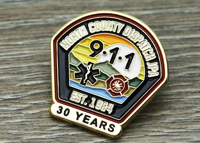 A years of service pin for North County Dispatch, celebrating 30 years since 1990, featuring emergency service icons and a colorful background.