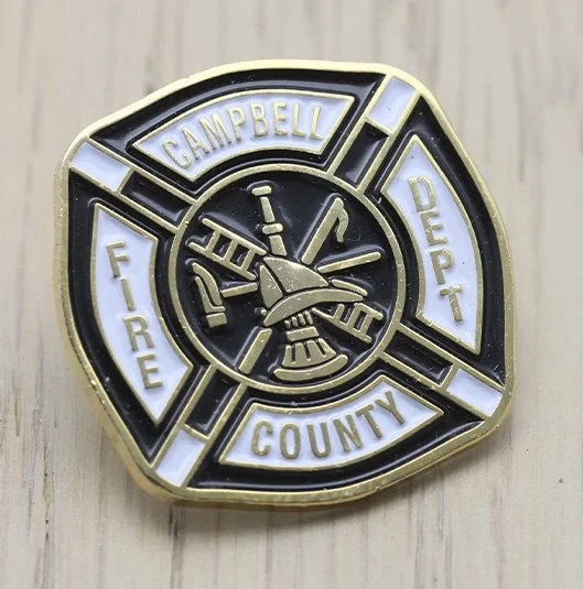 Fire department service pin for Campbell County Fire Department with a Maltese cross shape, featuring a firefighter's helmet and tools in the center.