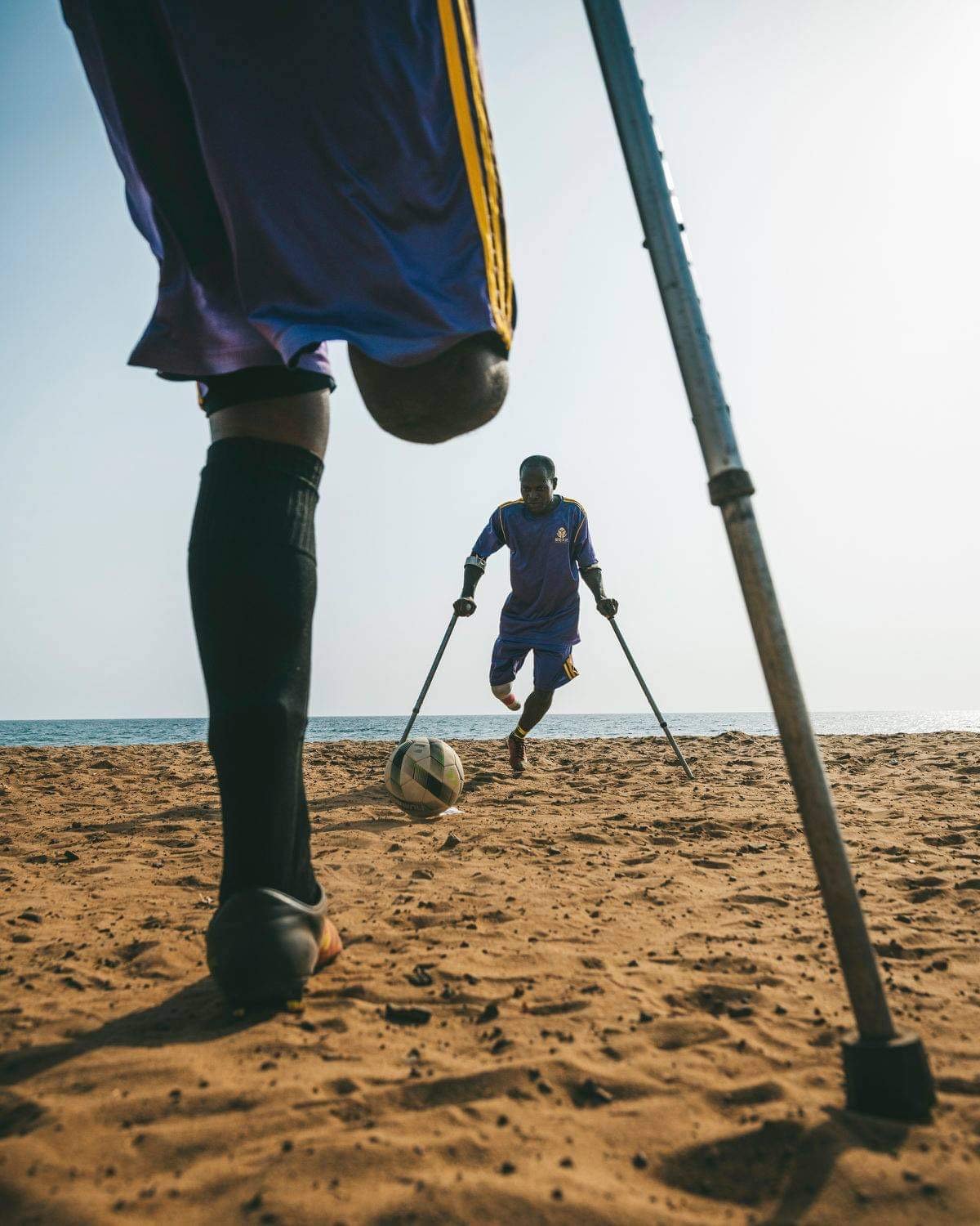 Spillere fra Flying Stars Amputees spiller fodbold på stranden i Sierra Leone.