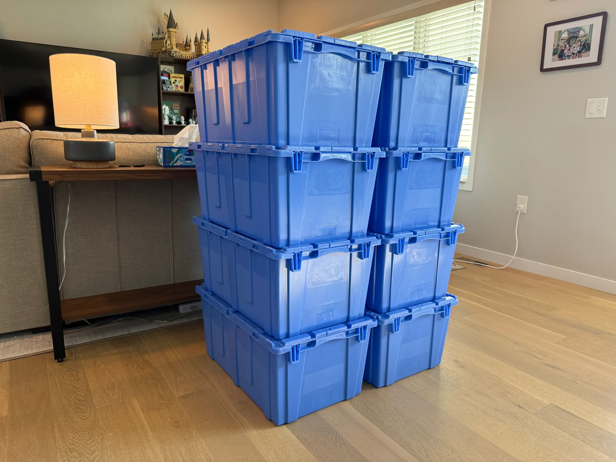 Reusable blue moving totes stacked in a living room, ready for packing — Totes to Go rental service in Kearney, NE