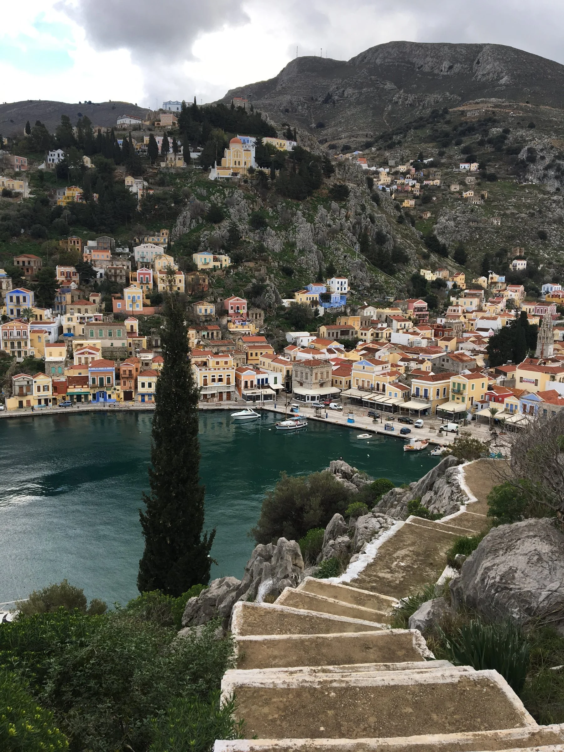 Descending a sea of pastel homes and timeless paths.