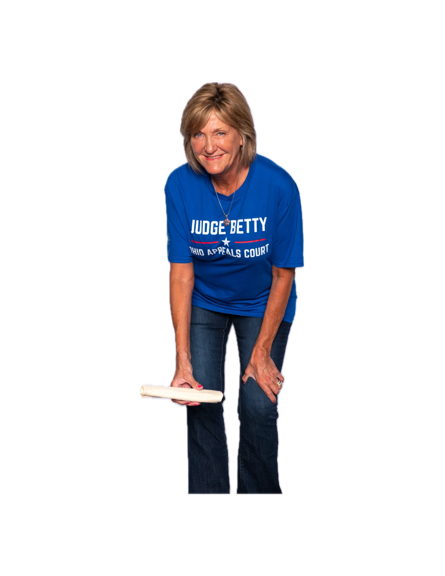 A woman wearing a blue T-shirt with the text 'Judge Betty Ohio Appeals Court' printed on it. She is smiling, leaning forward, and holding a wooden rolling pin with both hands, against a plain white background.