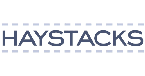 This logo says the word HAYSTACKS in navy blue with a gray dashed line above and below on a white background