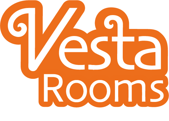 Logo for Vesta Rooms with the word 'Vesta' in white with orange outline and swirl designs, and 'Rooms' in white below.