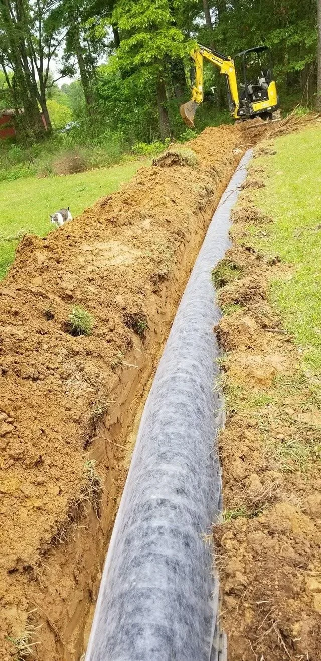 Installed drainage pipe system designed to improve water flow and prevent standing water on a residential property in Northwest Louisiana.