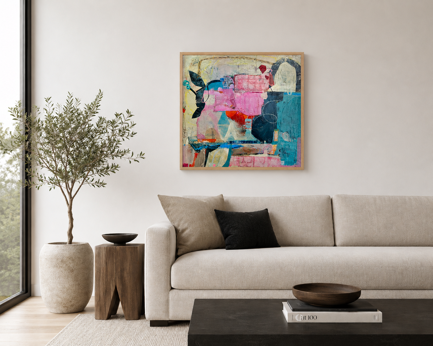 Modern living room with a beige sofa, black and beige pillows, a wooden side table, a large potted plant, abstract colorful painting, and a black coffee table with a bowl and books.