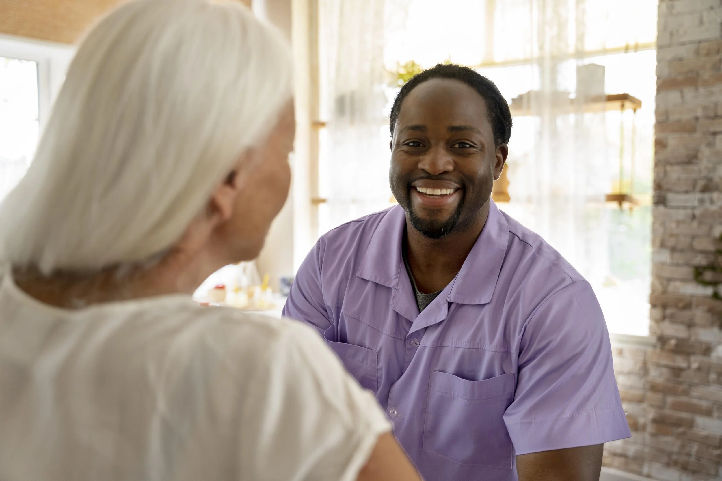 Home care aide assisting senior patient with daily activities