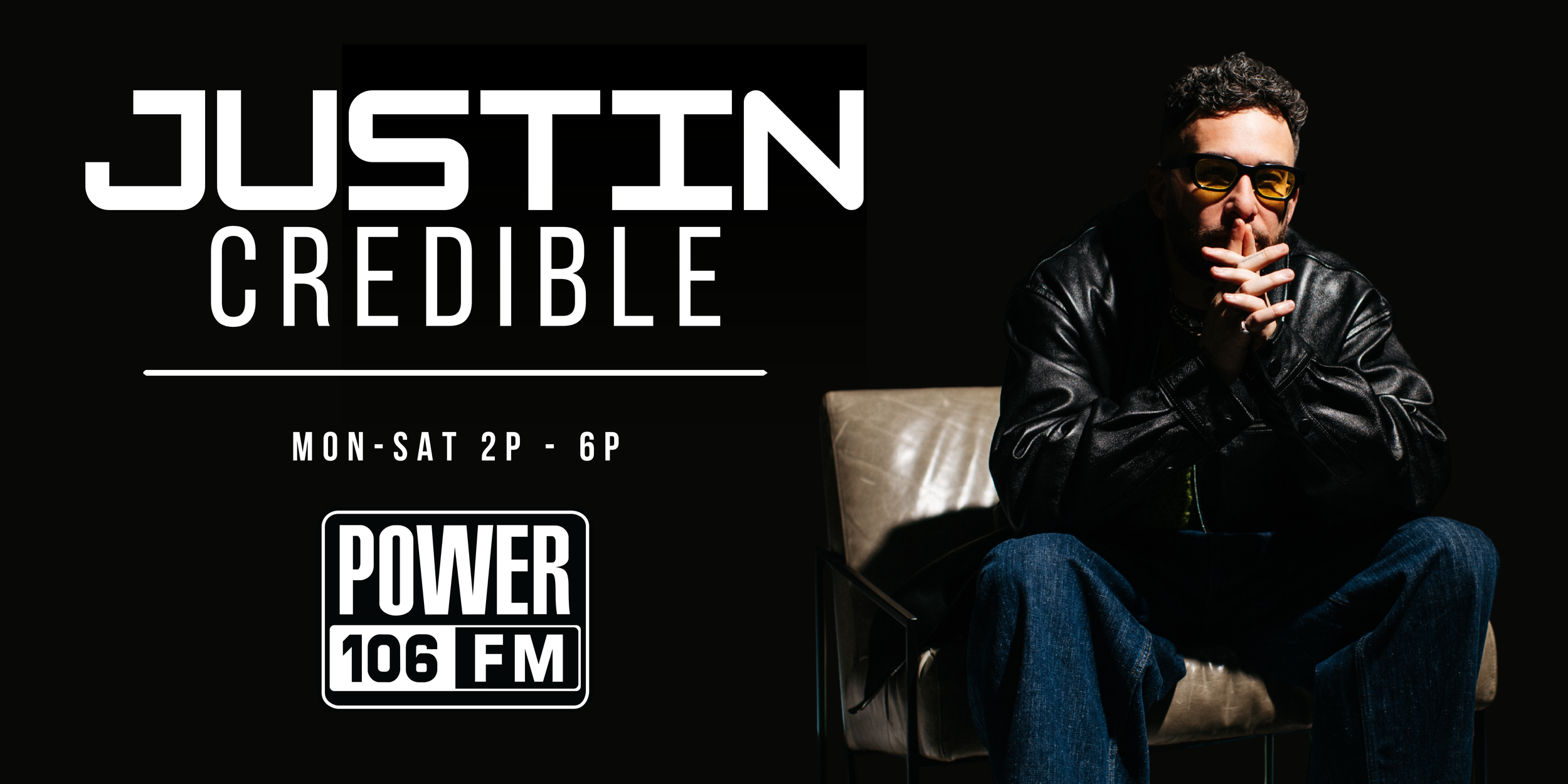 Promotional poster for a radio show featuring a man with curly hair, beard, wearing sunglasses and a black leather jacket seated on a chair, with text indicating the show's name 'Just In Credible' airs Monday to Saturday from 2 PM to 6 PM on POWER 106 FM.