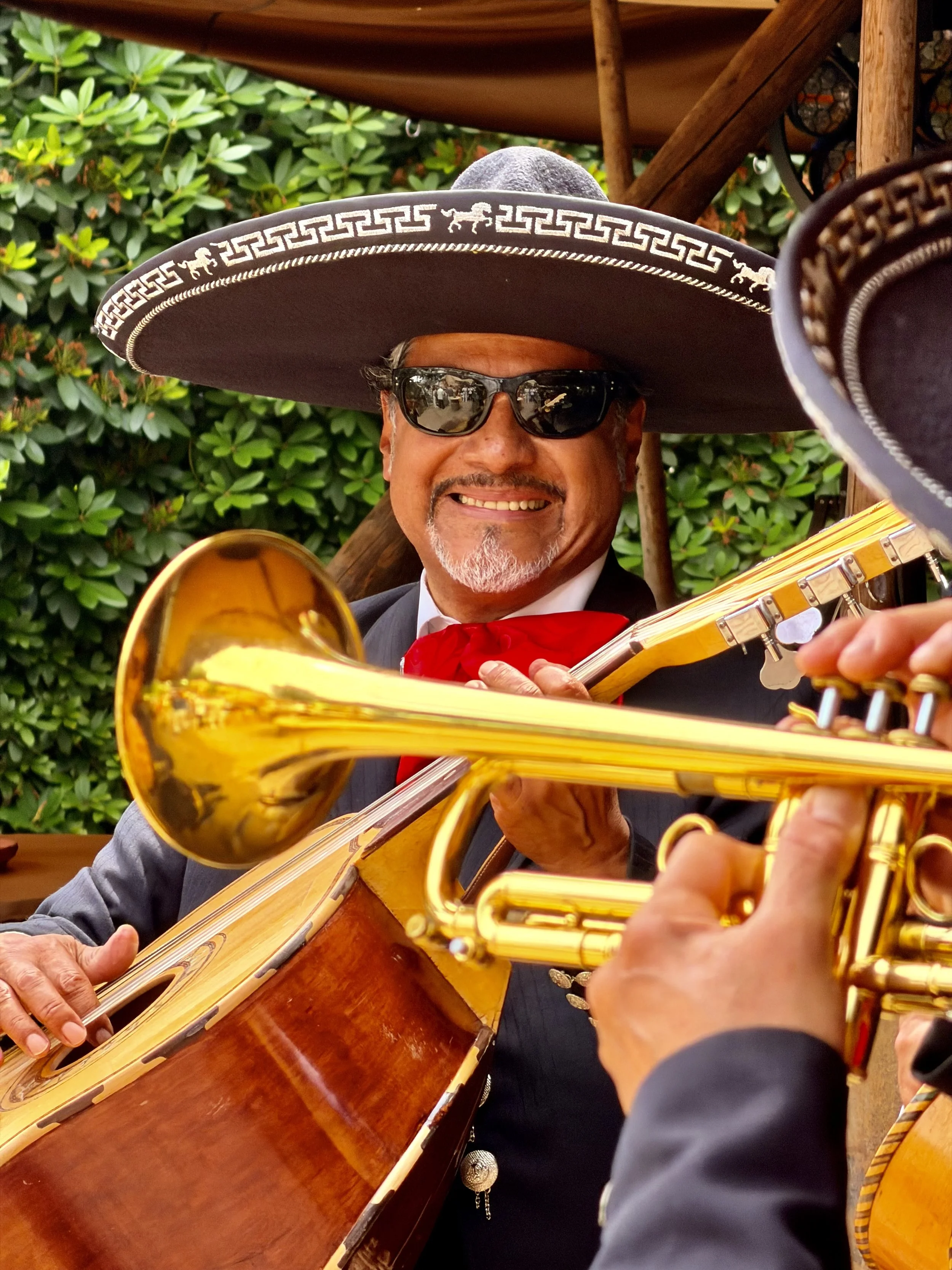 Mariachi musician in a sombrero and sunglasses playing the trumpet