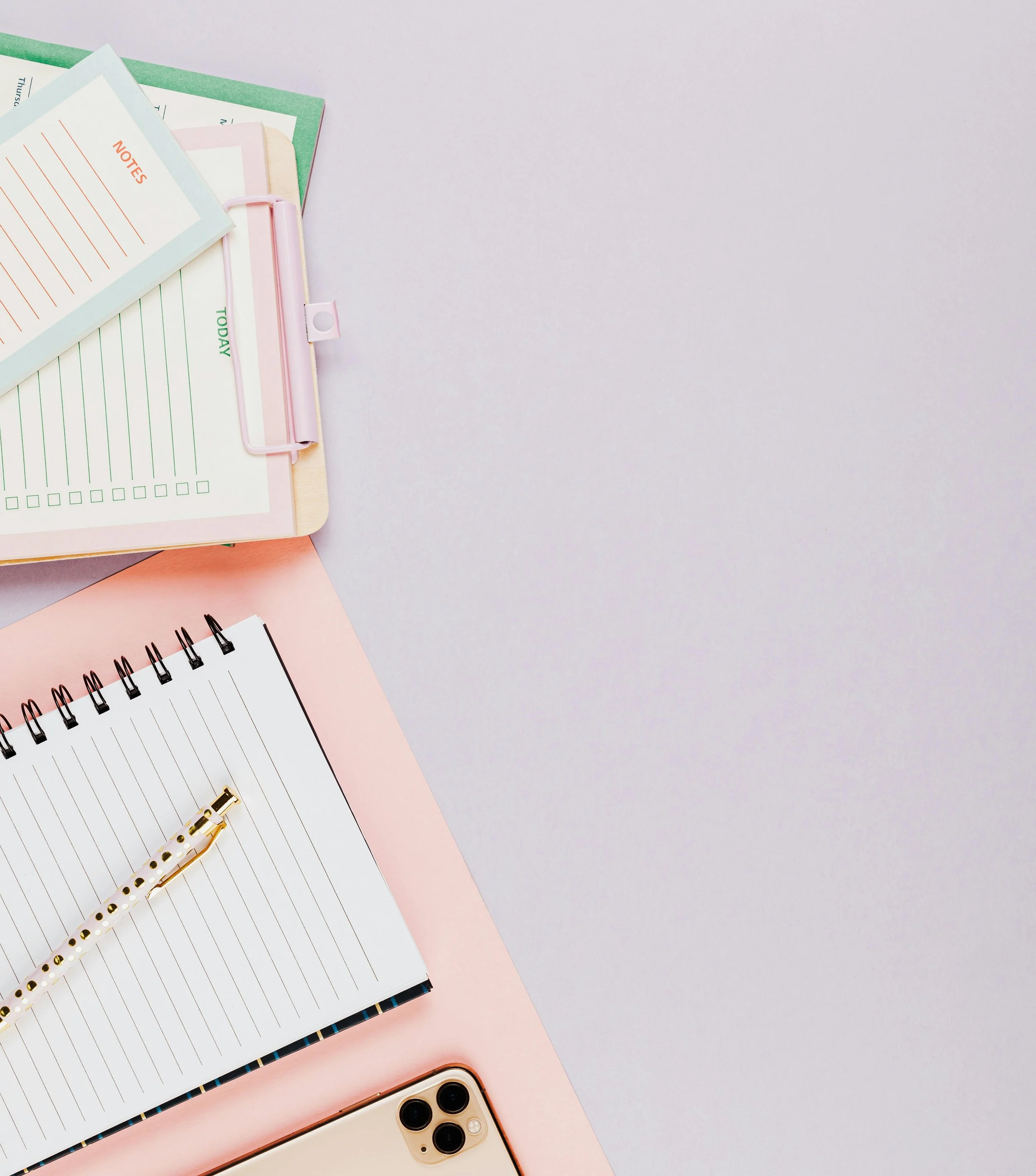 Planning notebook, phone and stationery representing everyday systems, organisation and small life resets