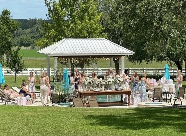Outdoor baby shower by the pool at Five Oaks Farm event venue in Alachua, Florida, with guests celebrating beside the gazebo