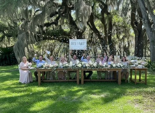Baby reveal celebration under the oak trees at Five Oaks Farm event venue in Alachua, Florida, with a decorated outdoor table and party setting