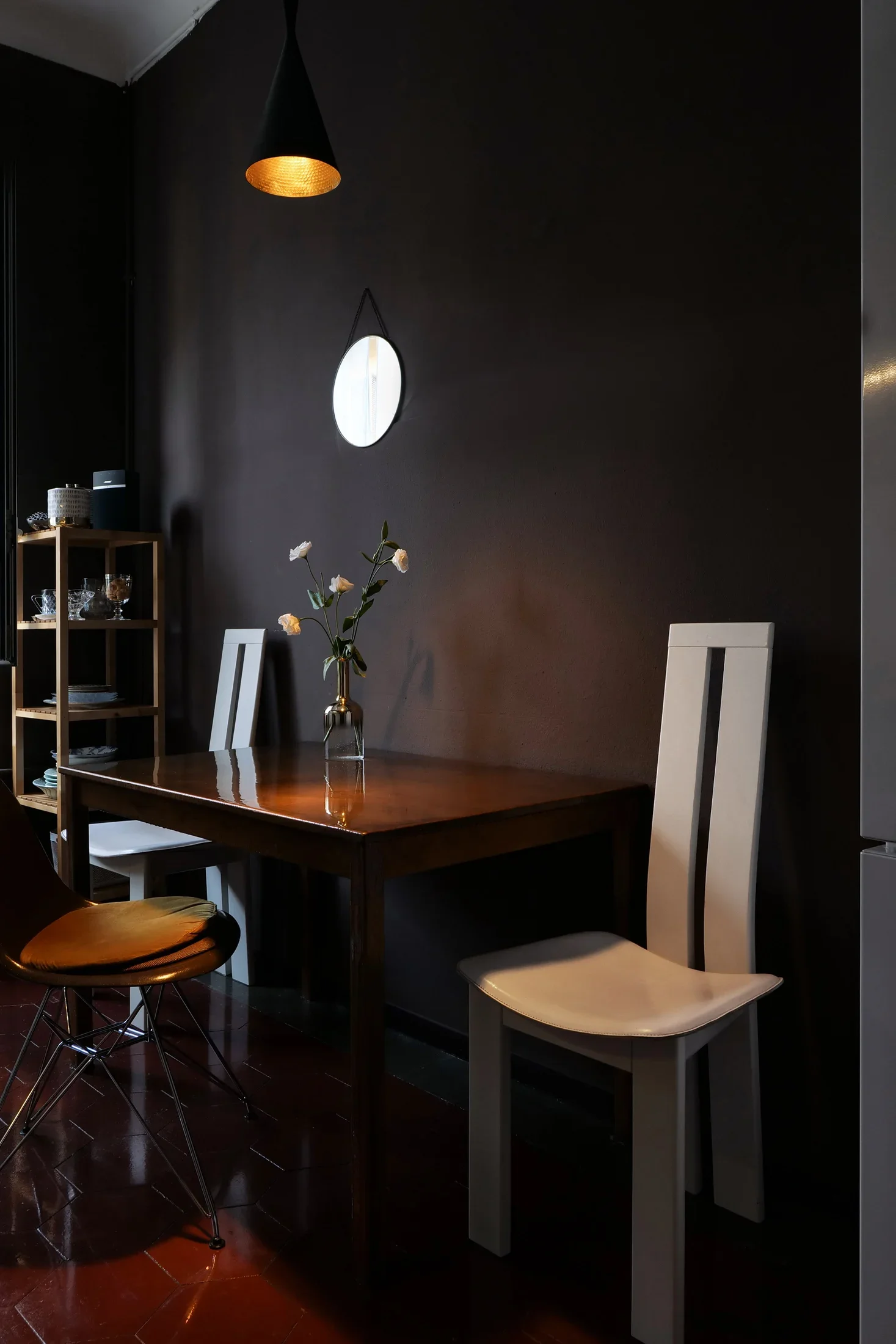 Kitchen corner with hand-resined table, Tom Dixon Beat pendant, Pietro Costantini white chairs and fiberglass Eames  DSR chair, House of Frames bed & breakfast, Milan