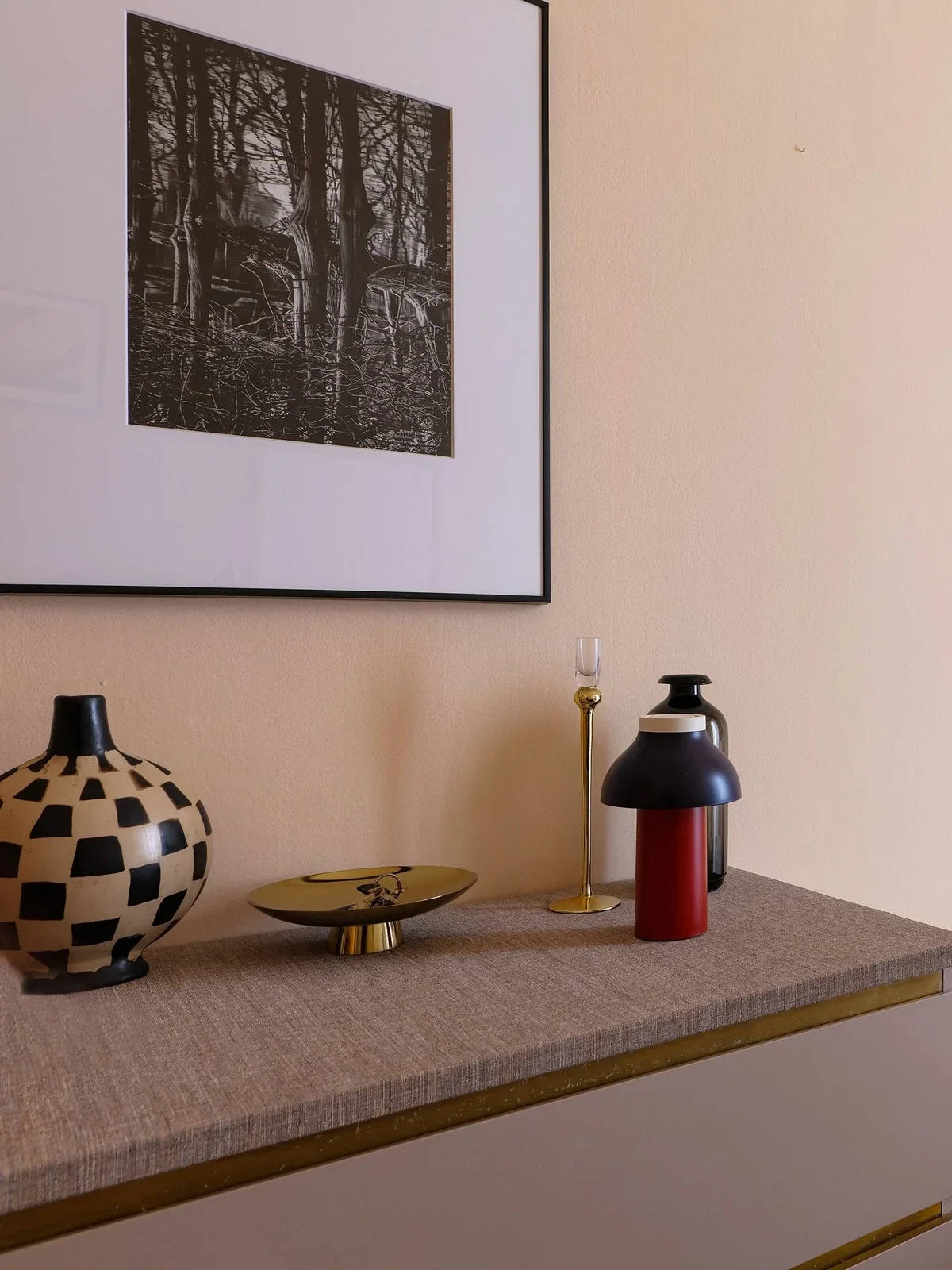 Forest-print art, checkerboard vase and red lamp, the SINGLE Room — House of Frames, Milan