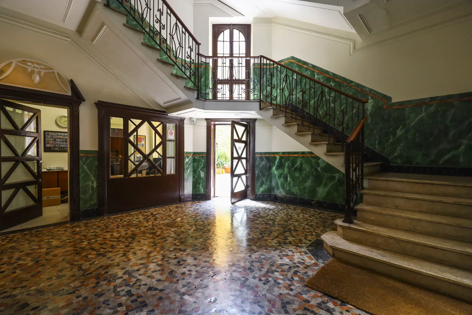 Green-marble staircase and Venetian terrazzo hall — House of Frames, boutique B&B Milan
