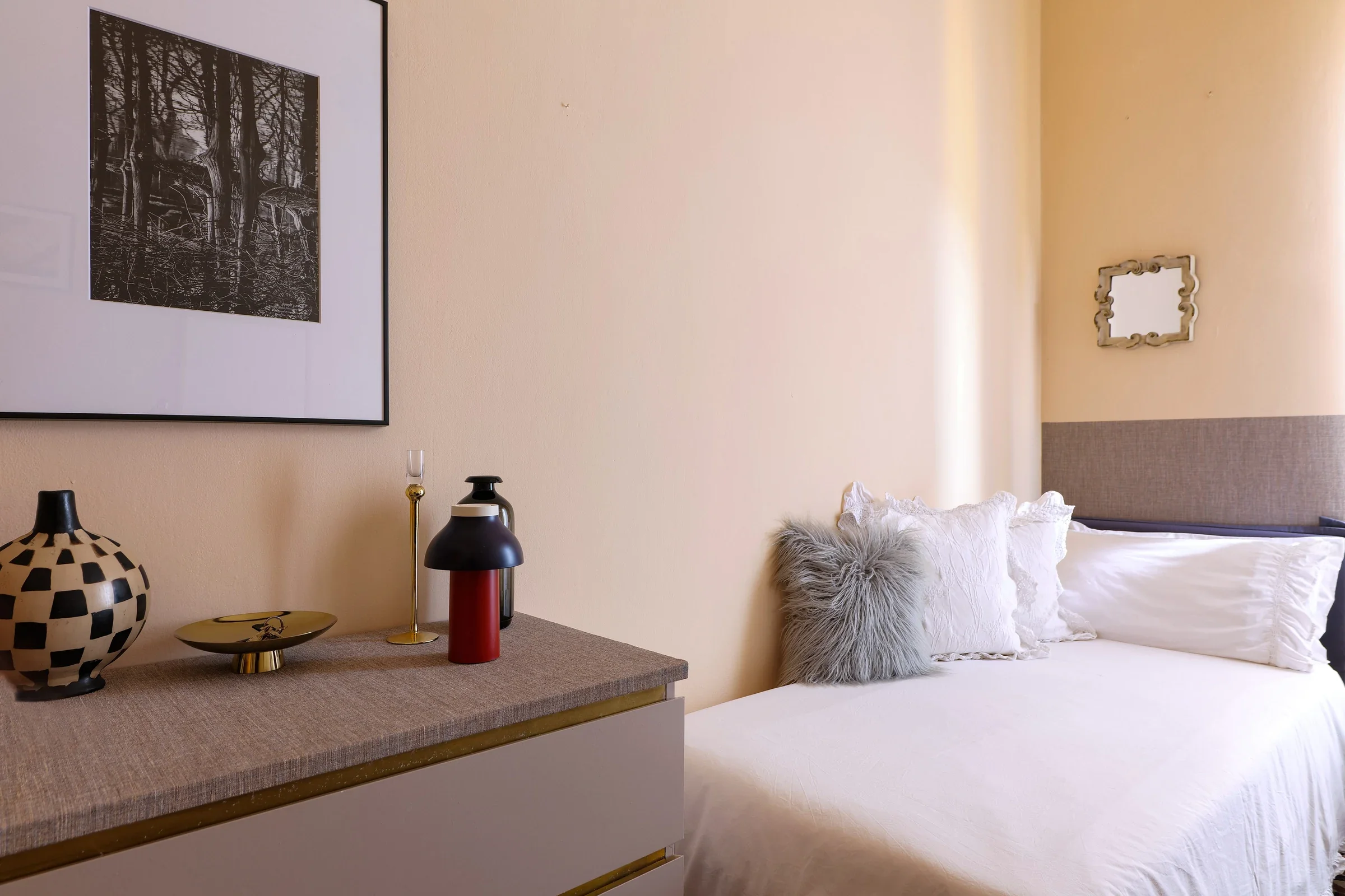 Decor-design bedside chest with checkerboard vase and red HAY portable lamp, single room — House of Frames, Milan