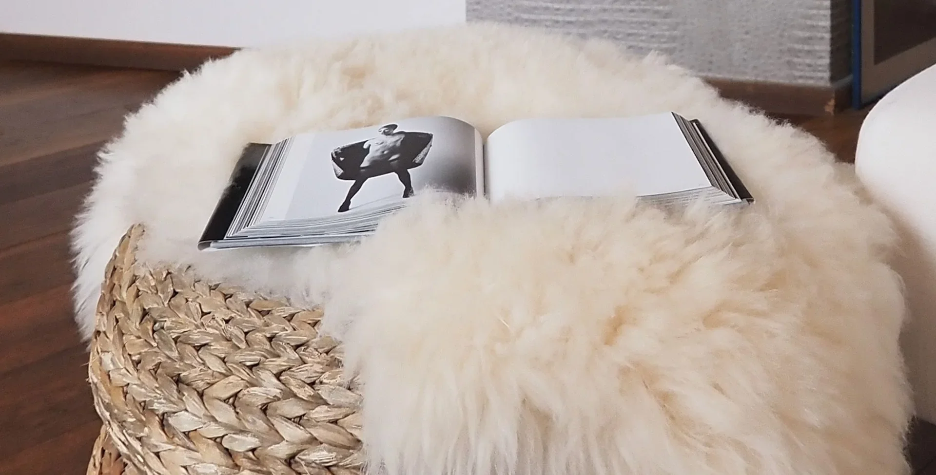 Open Robert Mapplethorpe photography book on a sheepskin pouf, Milan miniloft