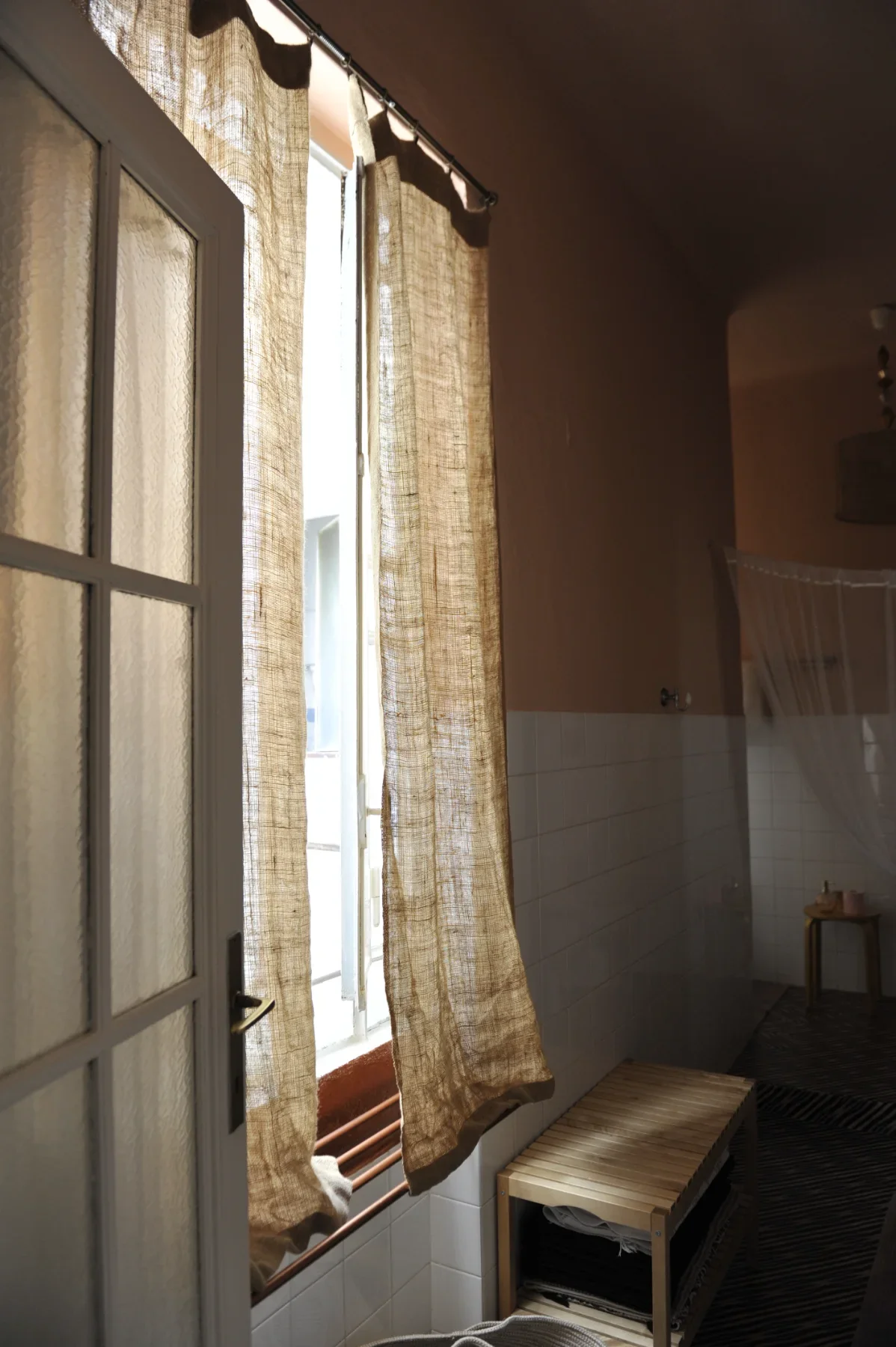 Raw-jute curtains and a wooden bench, jungle bathroom — House of Frames, design B&B Milan