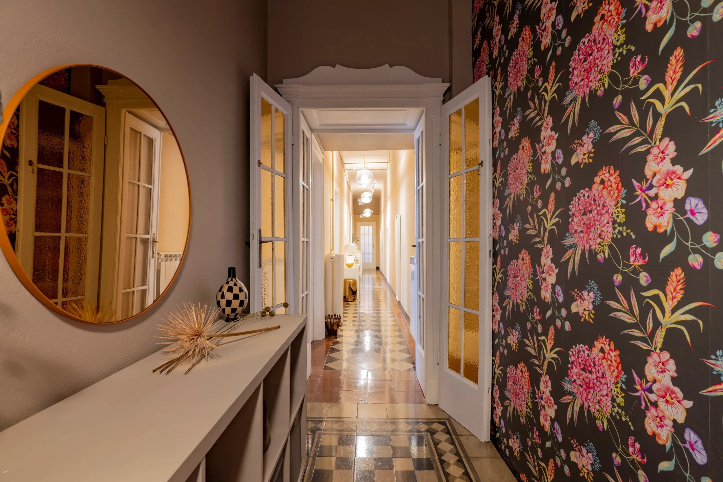 House of Frames Milan hallway with floral wallpaper, patterned cement tiles and glazed doors