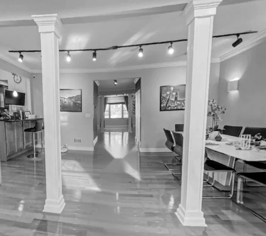 Villa US Residence before the intervention — original open living and kitchen with structural columns