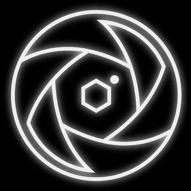A neon light design with a central hexagon surrounded by several curved lines forming a circular pattern against a black background.